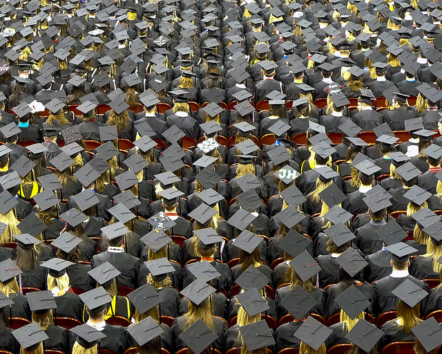 This photograph is a group of graduation students, taken from above, just showing their caps.