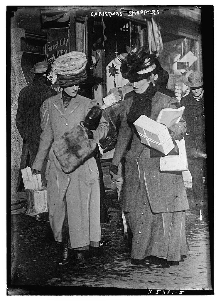 two women carry packages from a shopping trip