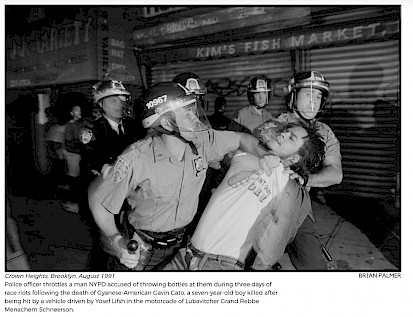 Crown Heights, Brooklyn, August 1991. Police officer throttles a man NYPD accused of throwing bottles at them during three days of race riots following the death of Cyanese-American Gavin Cato, a seven-year-old boy killed after being hit by a vehicle driven by Yosef Lifsh in the motorcade of Lubavitcher Grand Rebbe Menachem Schneerson