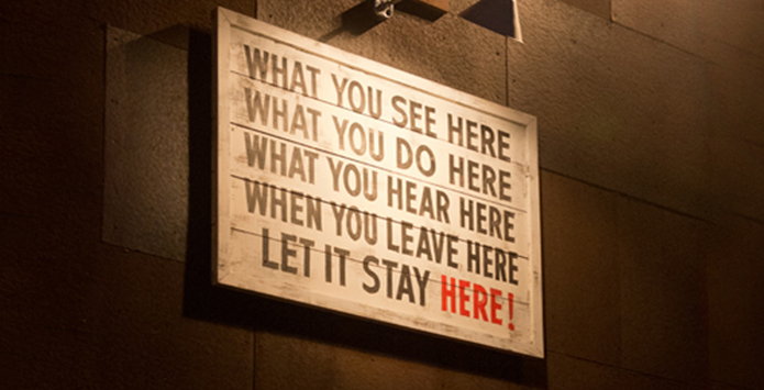 A sign which reads 'What you see here, what you do here, what you hear here, when you leave here, let it stay here!'