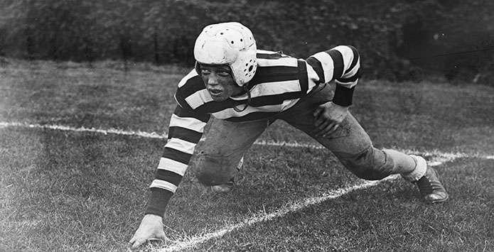 A football player crouched down in a pre-snap stance