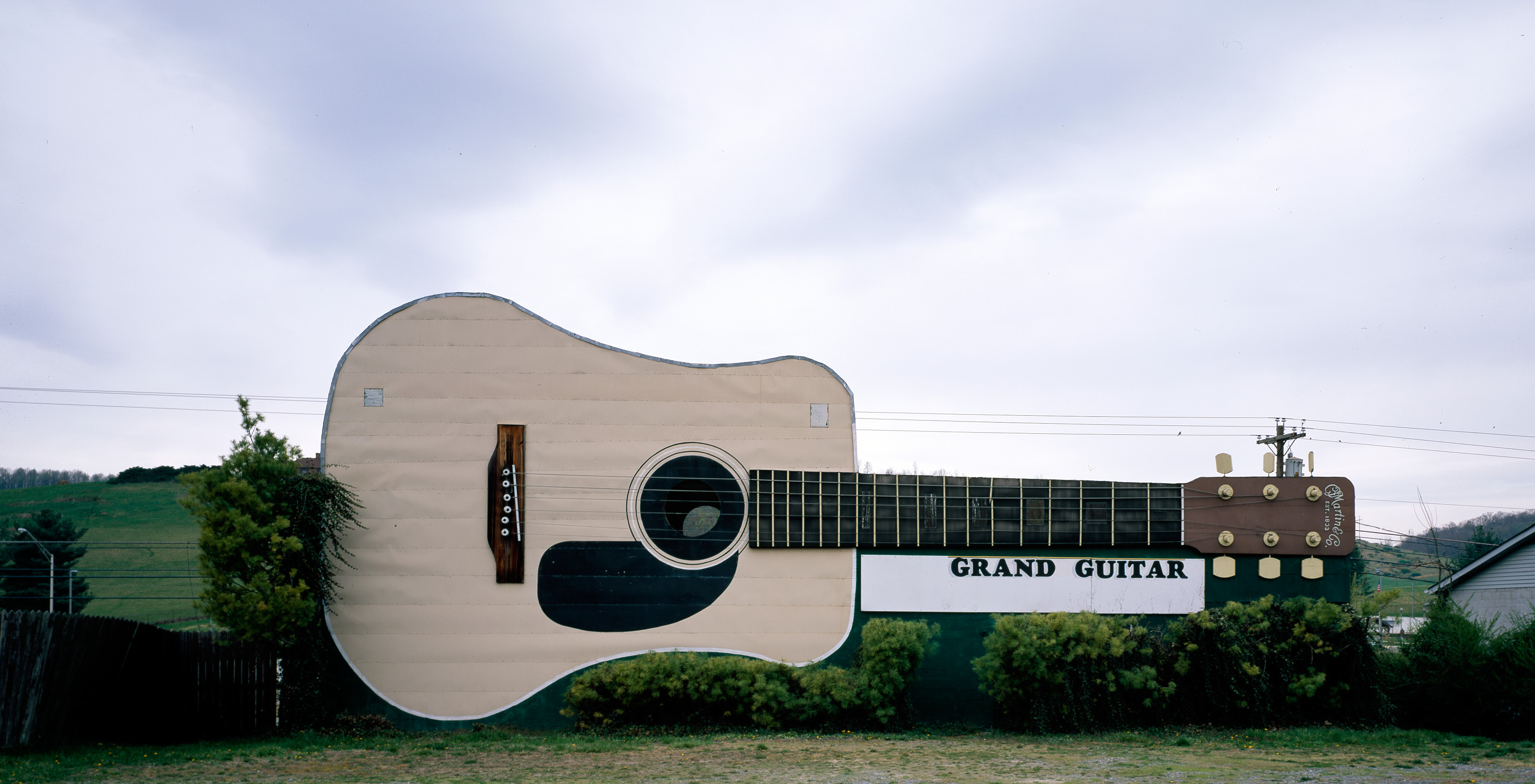Large guitar with a sign that reads 'Grand guitar'