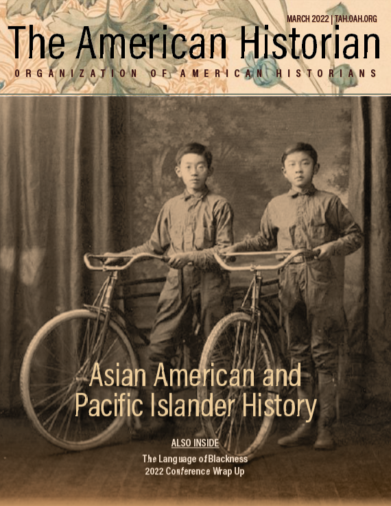 Two Japanese American boys hold their bicycles