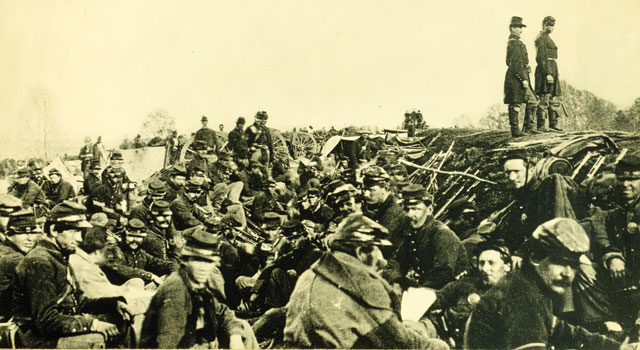 An 1863 photograph of Civil War soldiers huddled in trenches