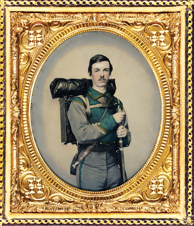 A confederate soldier posing with a gun and pack